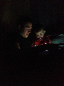 Jeff and Jack reading books by flashlight.